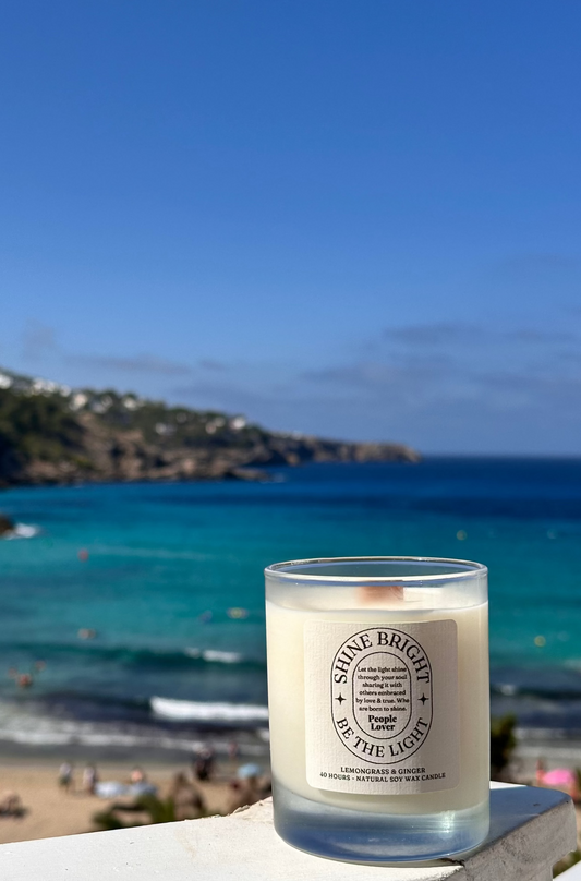 Candle with a beach and ocean view in the background